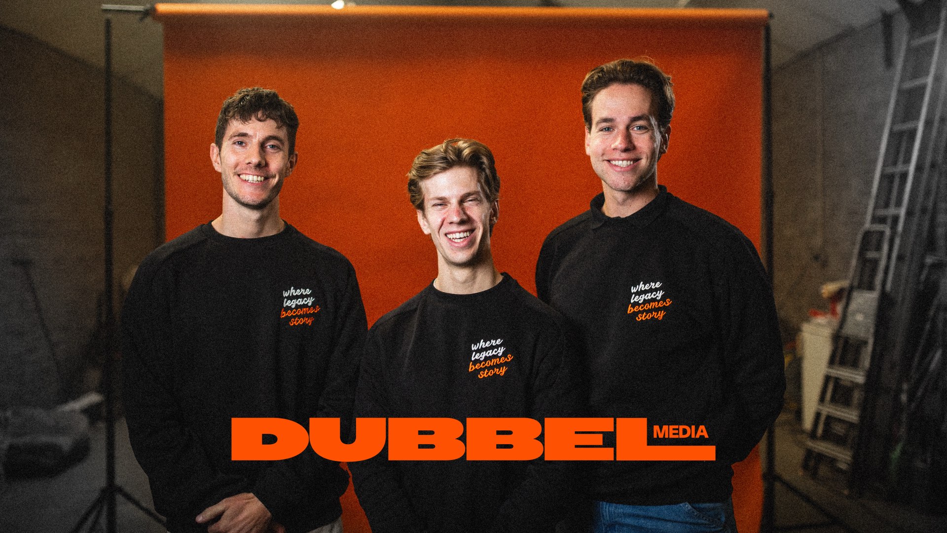 De drie neven van Dubbel Media voor een oranje doek, still uit de brandvideo 2026